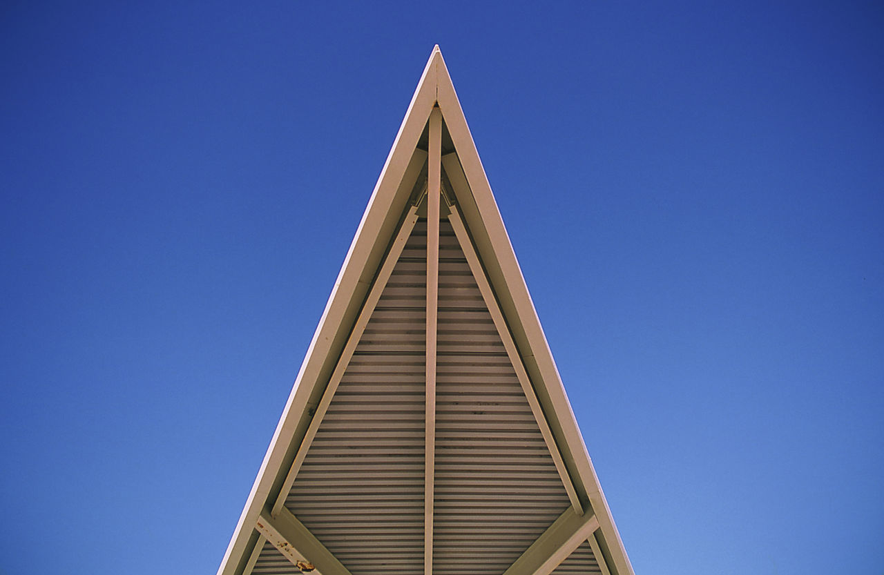 Low angle view of modern building against clear blue sky