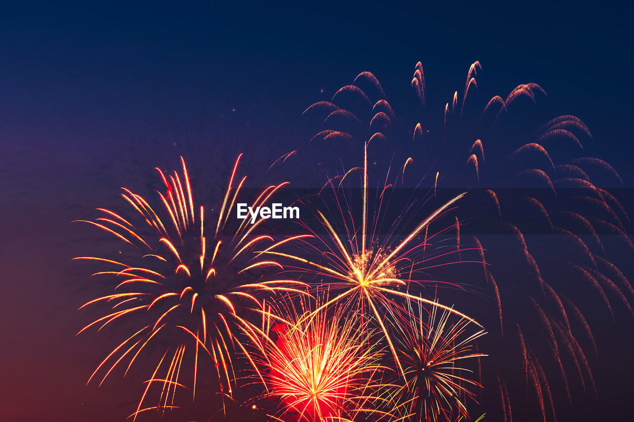 fireworks, celebration, night, event, firework display, motion, exploding, arts culture and entertainment, illuminated, sky, nature, no people, recreation, new year's eve, multi colored, firework - man made object, glowing, long exposure, low angle view, outdoors, blurred motion, beauty in nature, red, emotion