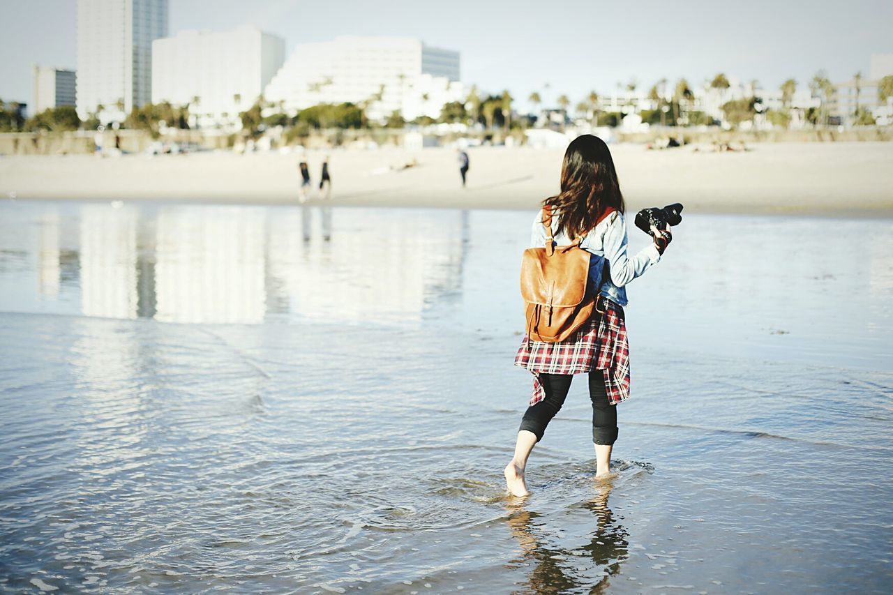 WOMAN STANDING IN WATER