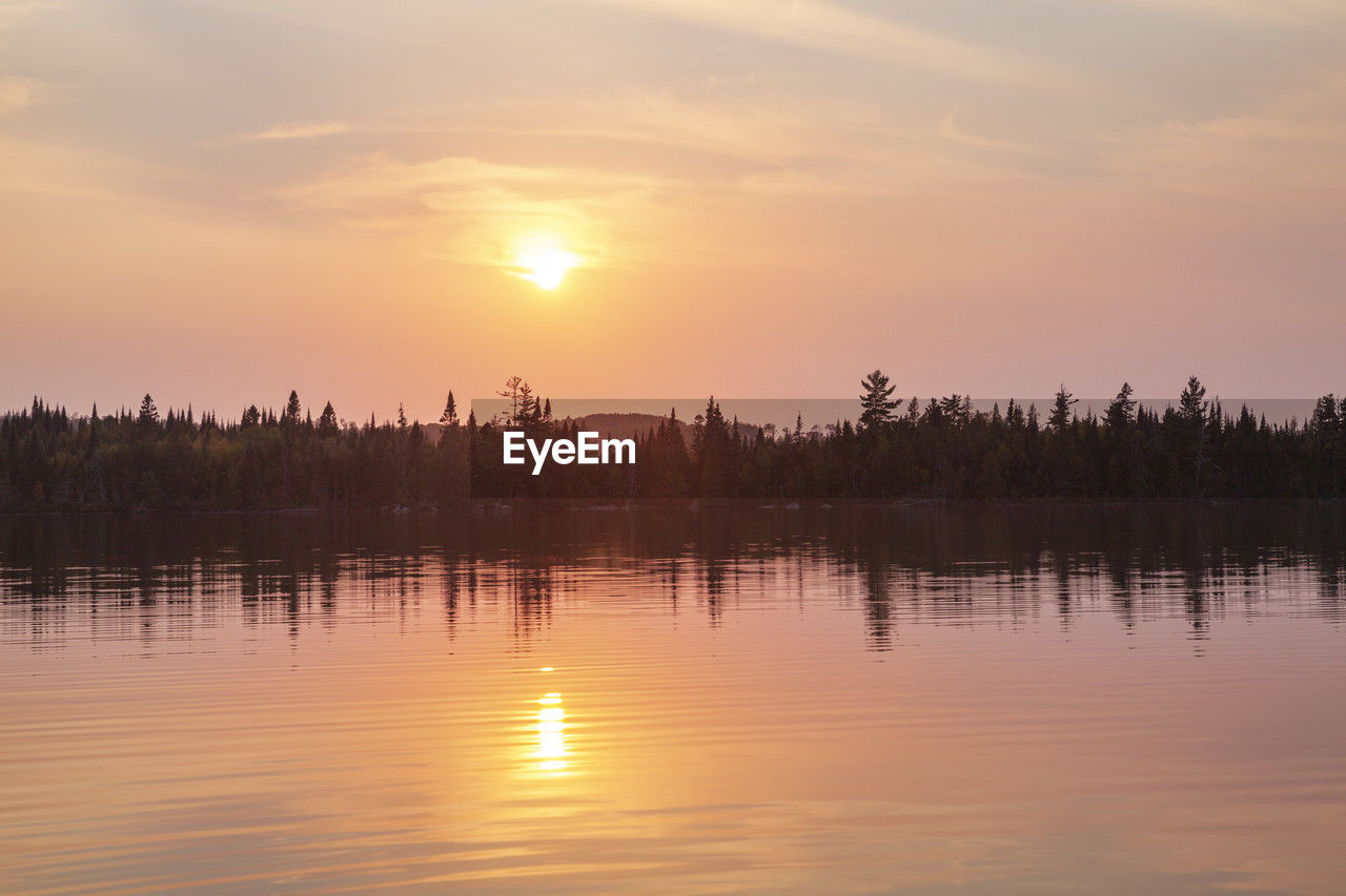 scenic view of lake at sunset