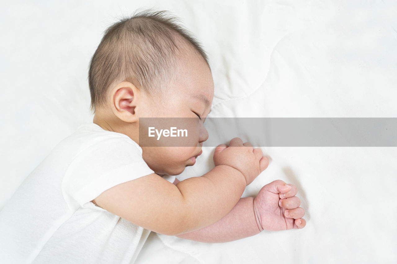 Baby girl sleeping on bed