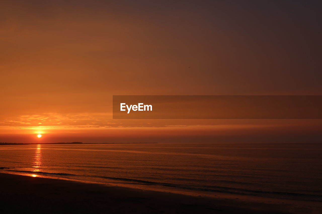 SCENIC VIEW OF SUNSET OVER SEA