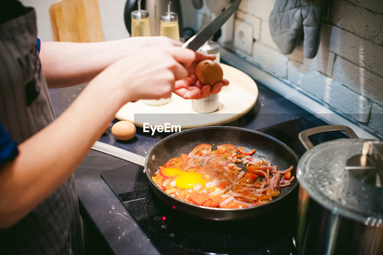 Midsection of woman preparing food in kitchen