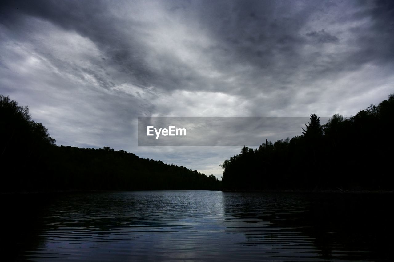 VIEW OF LAKE AGAINST CLOUDY SKY