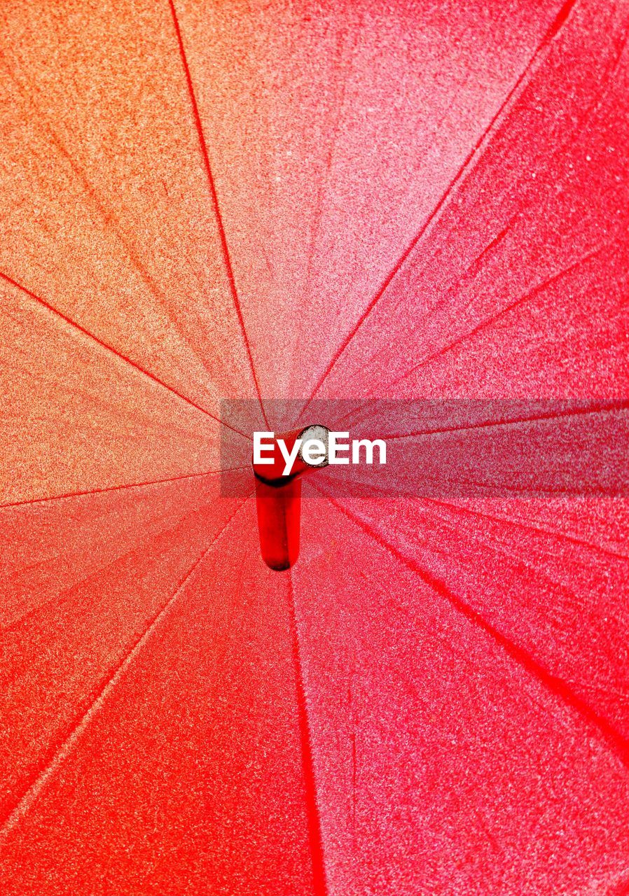 Low angle view of red umbrella on ceiling