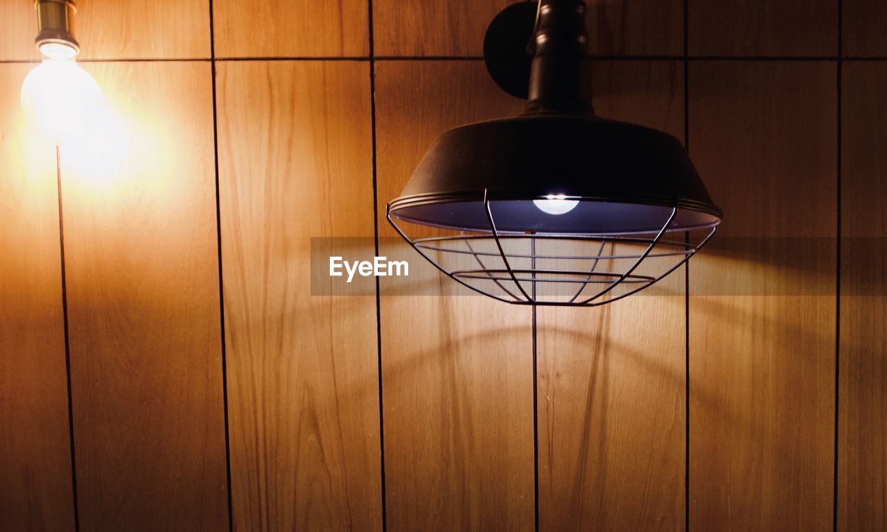 Close-up of illuminated lamp on wall