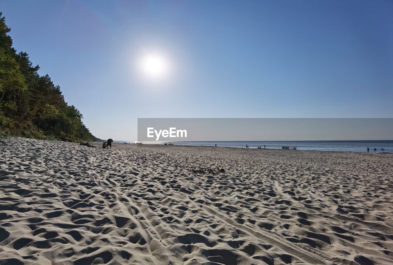 Scenic view of beach against clear sky