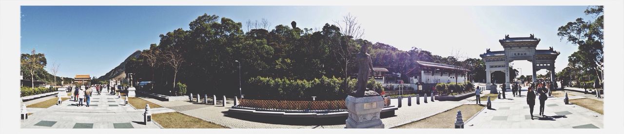 Panoramic view of trees amidst road leading to temple