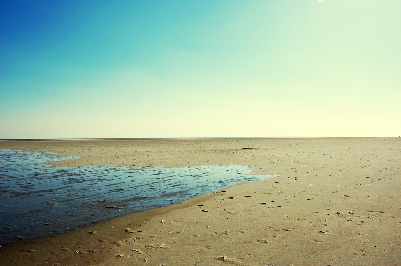 Scenic view of beach against clear sky