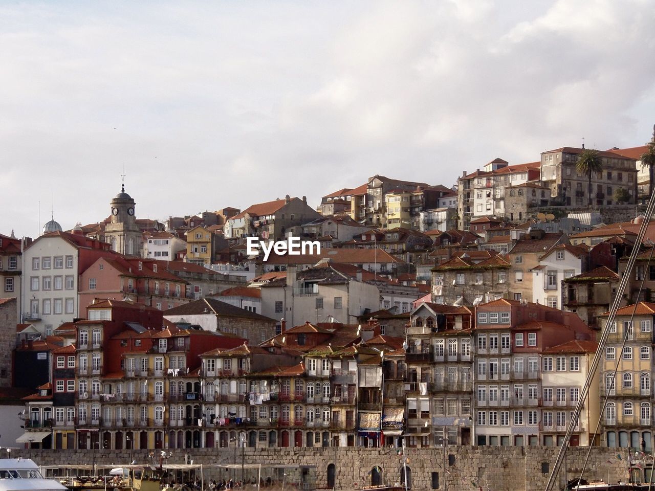 Buildings in city against cloudy sky