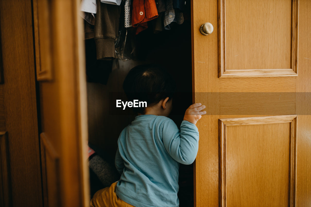 Child playing in the closet