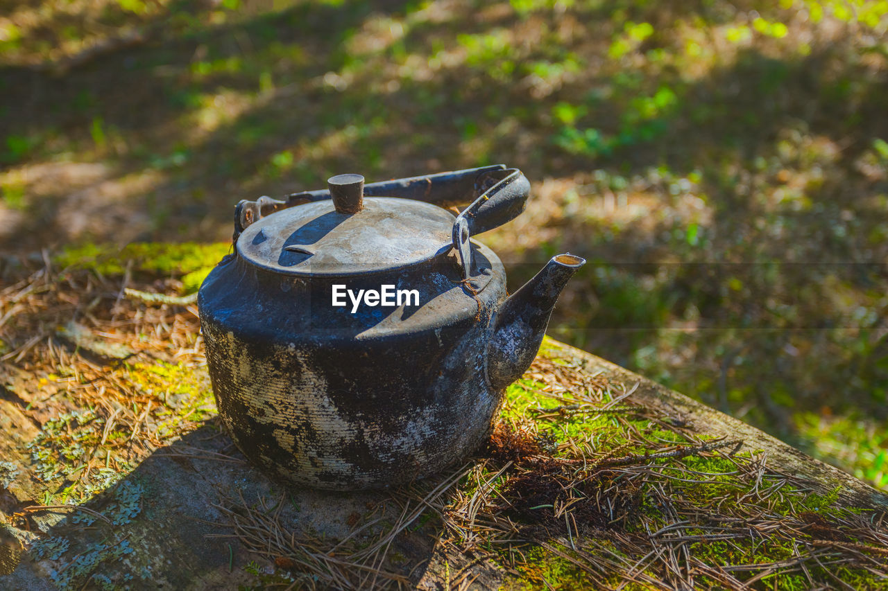 CLOSE-UP OF OLD RUSTY METAL ON FIELD