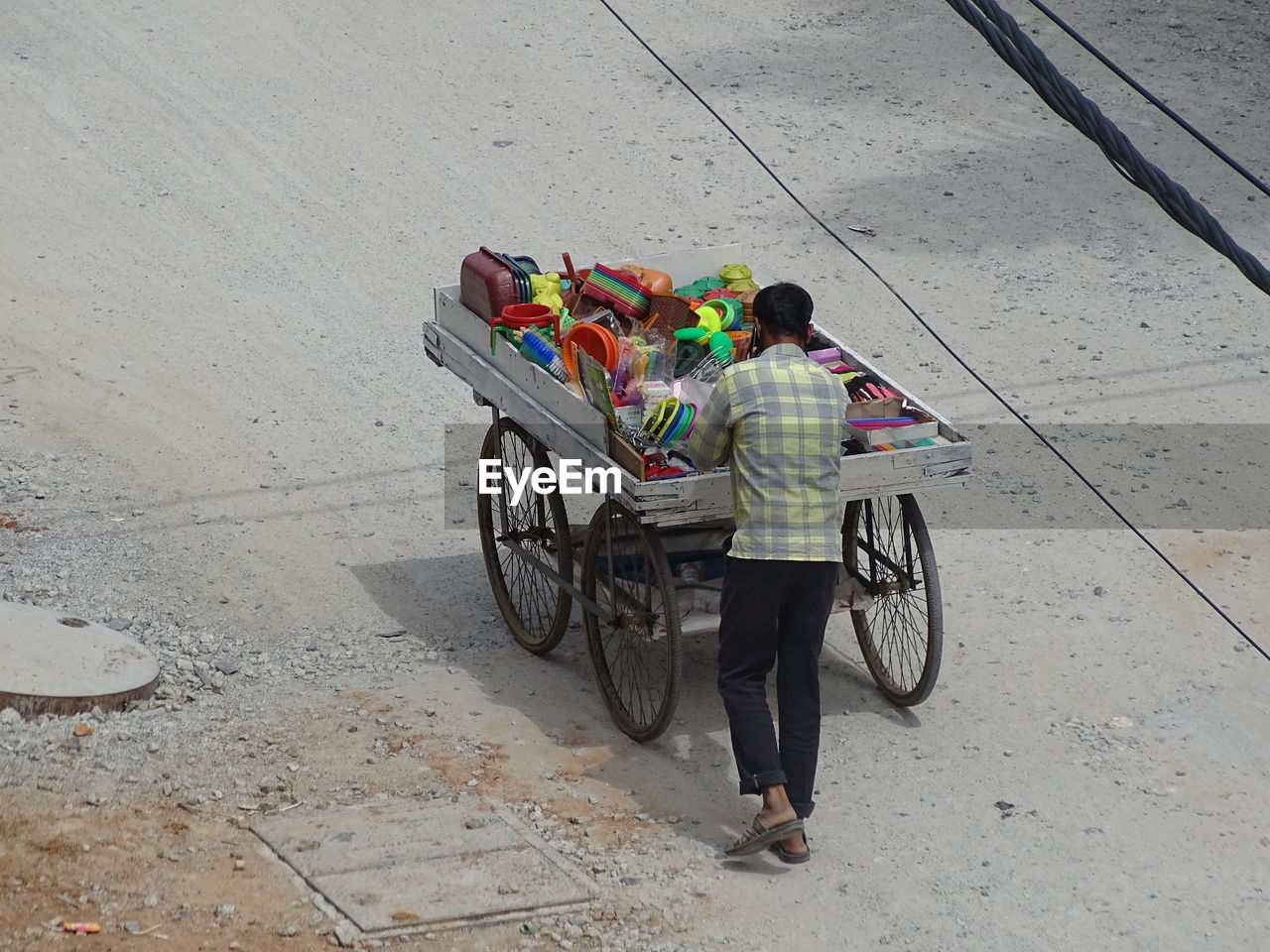 HIGH ANGLE VIEW OF PEOPLE RIDING BICYCLE