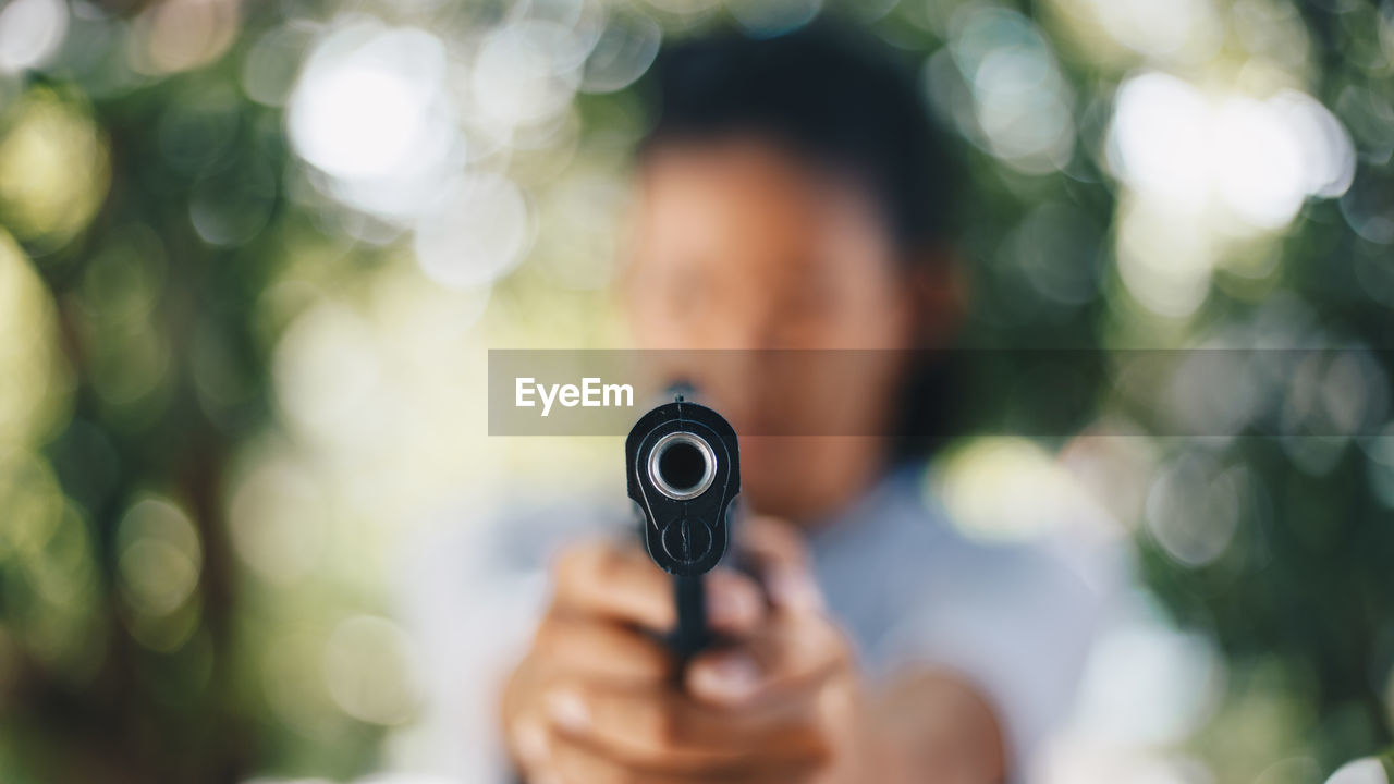Close-up of woman holding handgun