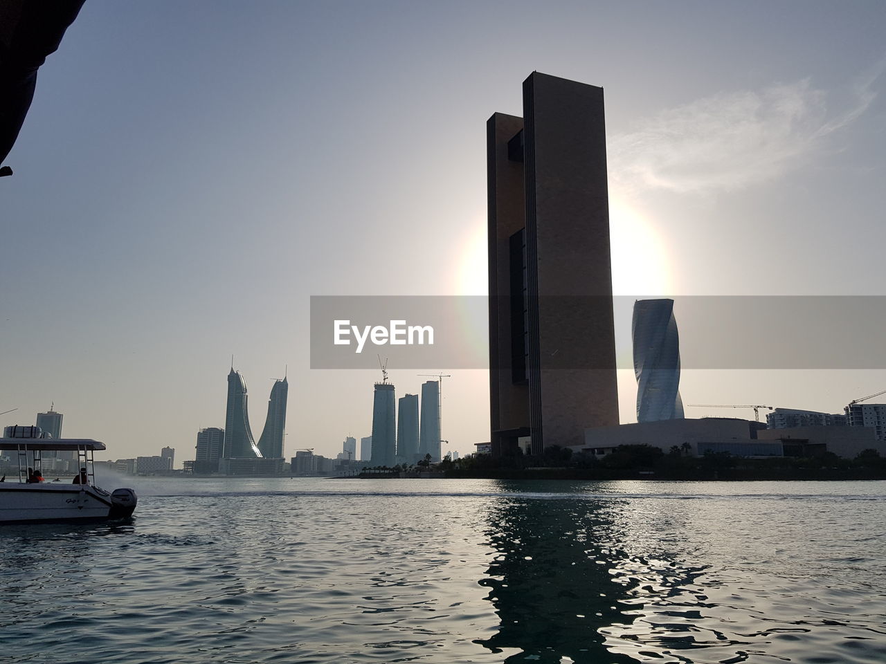 SCENIC VIEW OF CITY BUILDINGS AGAINST SKY DURING SUNSET