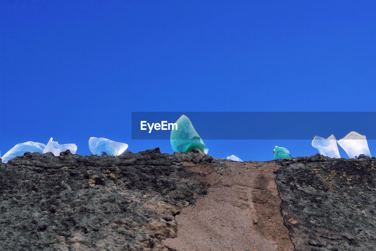 LOW ANGLE VIEW OF ROCKS AGAINST CLEAR SKY