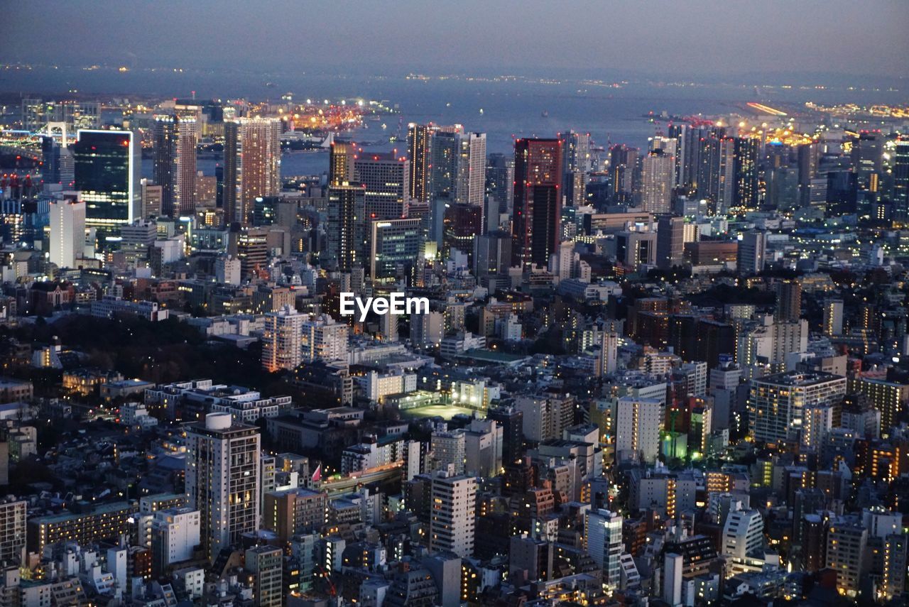 Aerial view of illuminated buildings in city at night