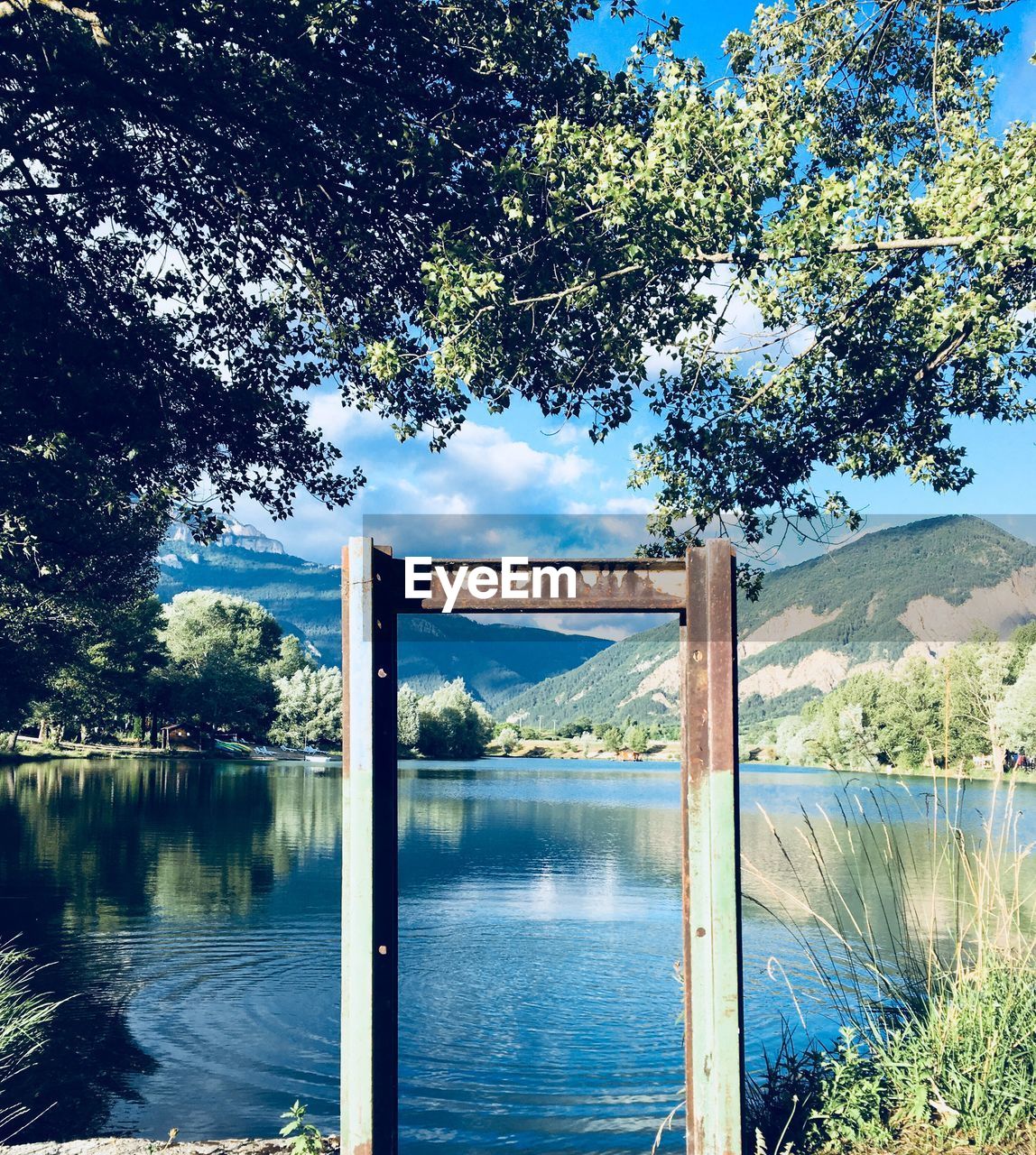 Arch bridge over lake against sky