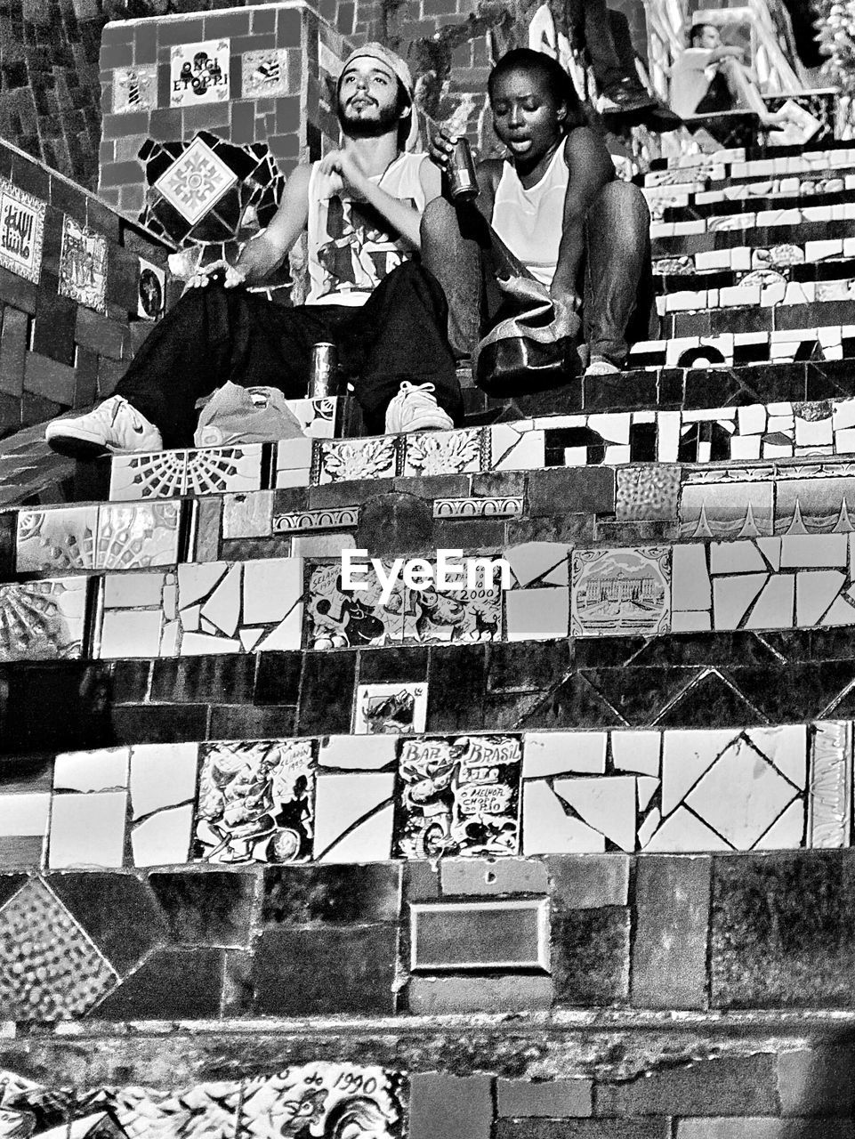 Low angle view of two people sitting on stairs