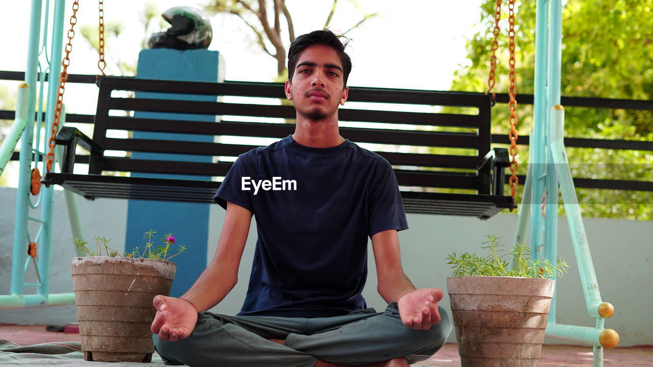 Portrait of young man sitting outdoors