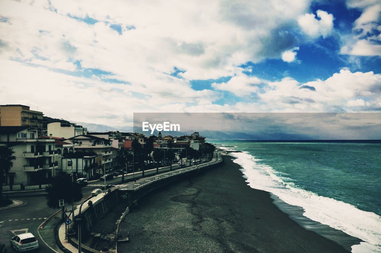 Panoramic view of beach and buildings against sky