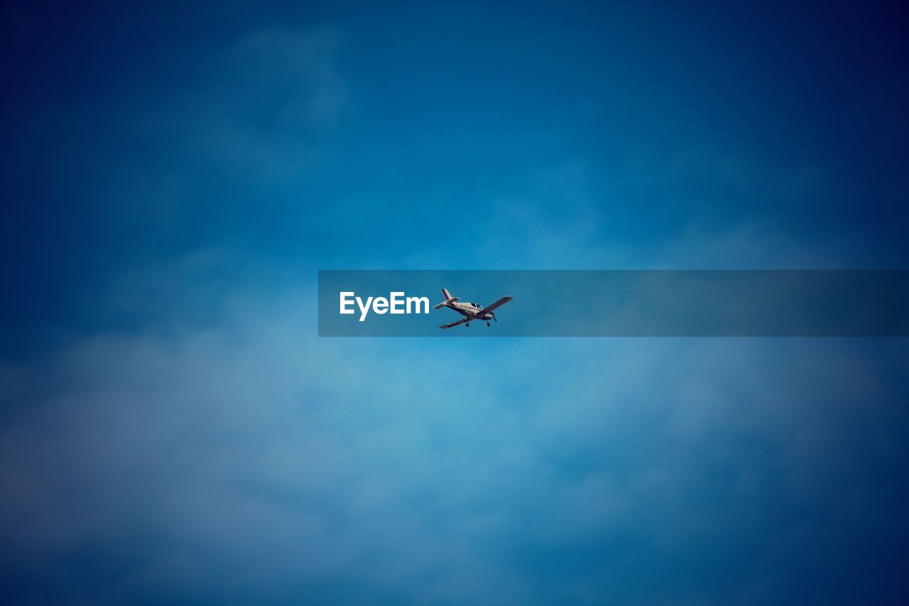 Low angle view of airplane flying in sky