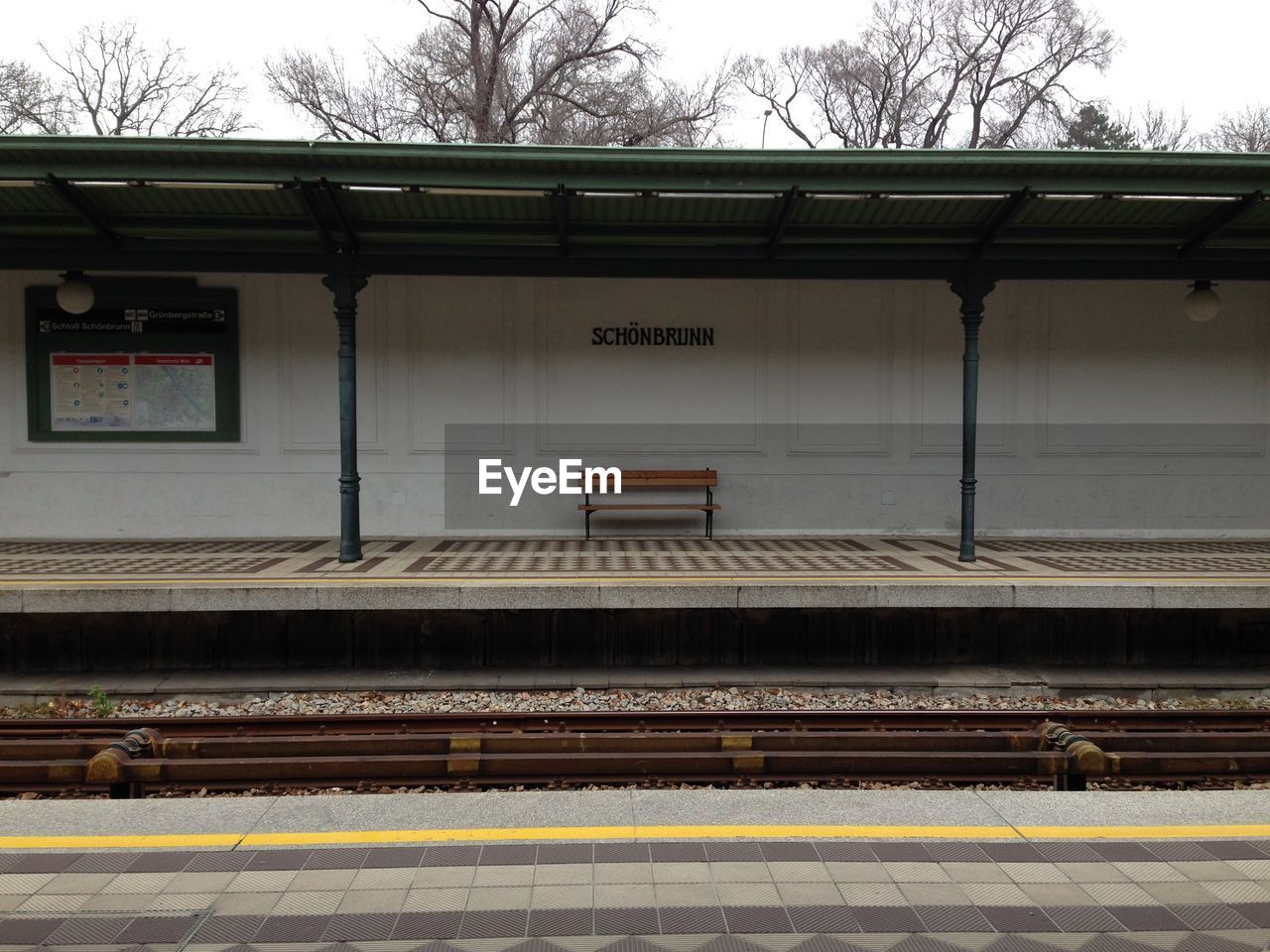 Empty bench at railroad station platform