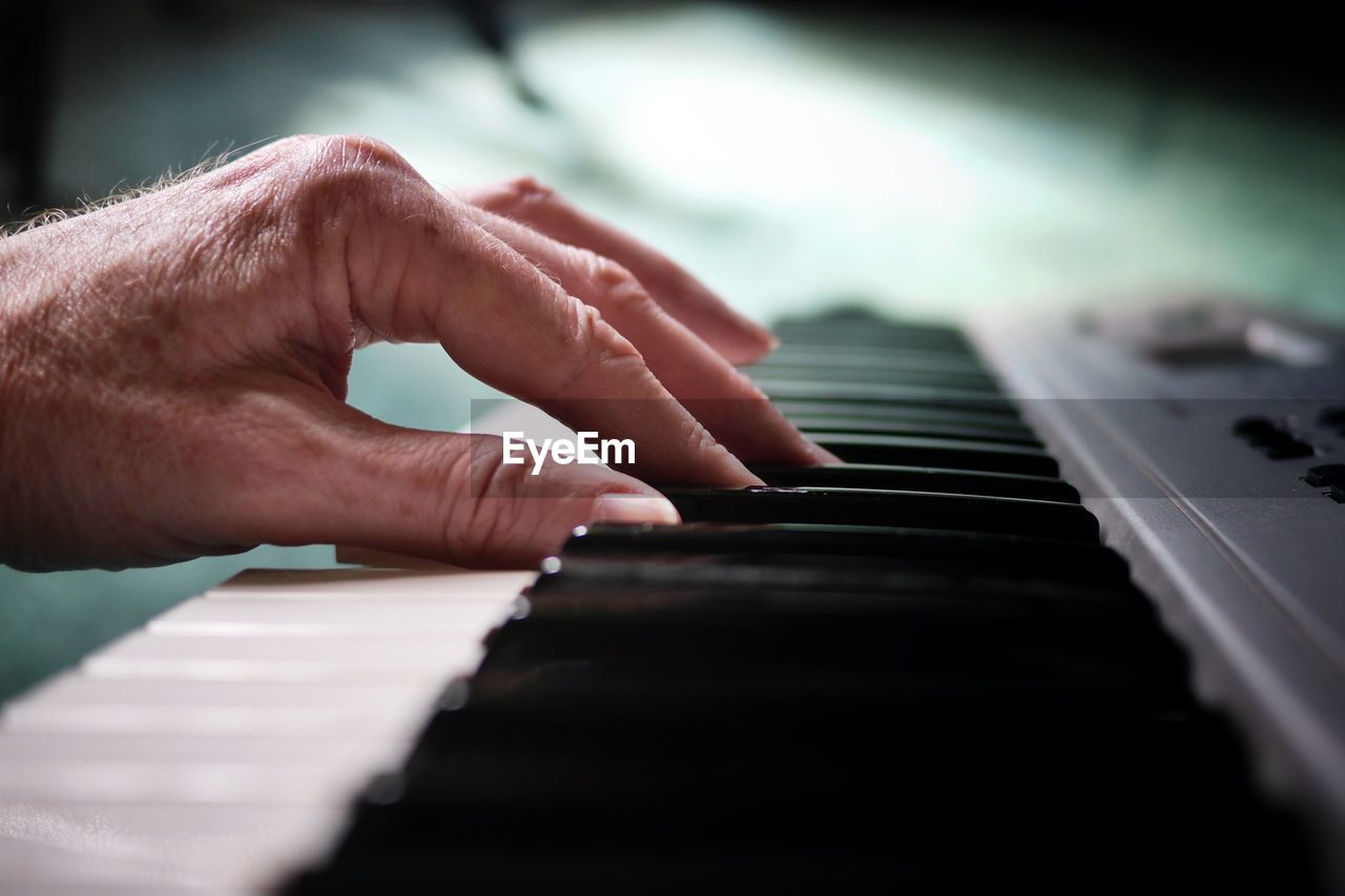 cropped image of man playing piano