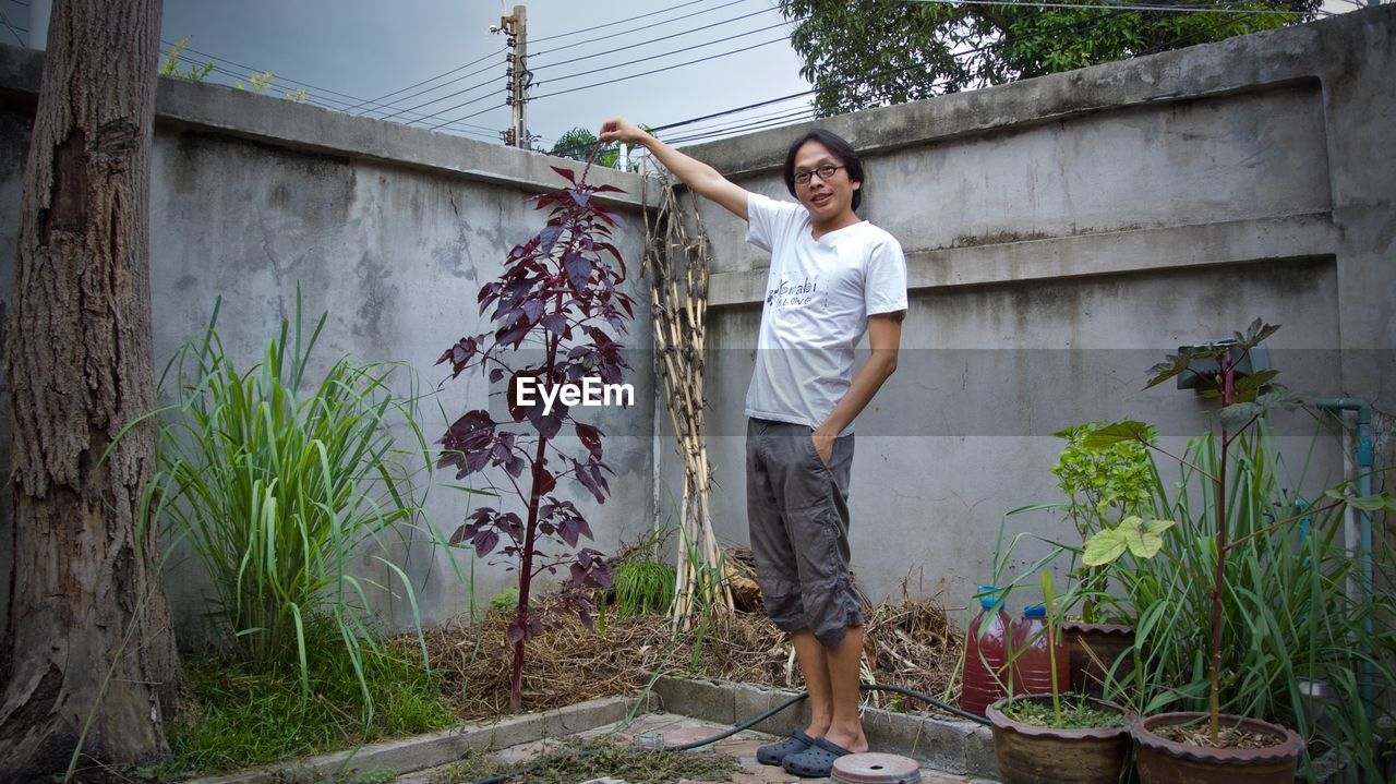 Portrait of mature man standing in yard