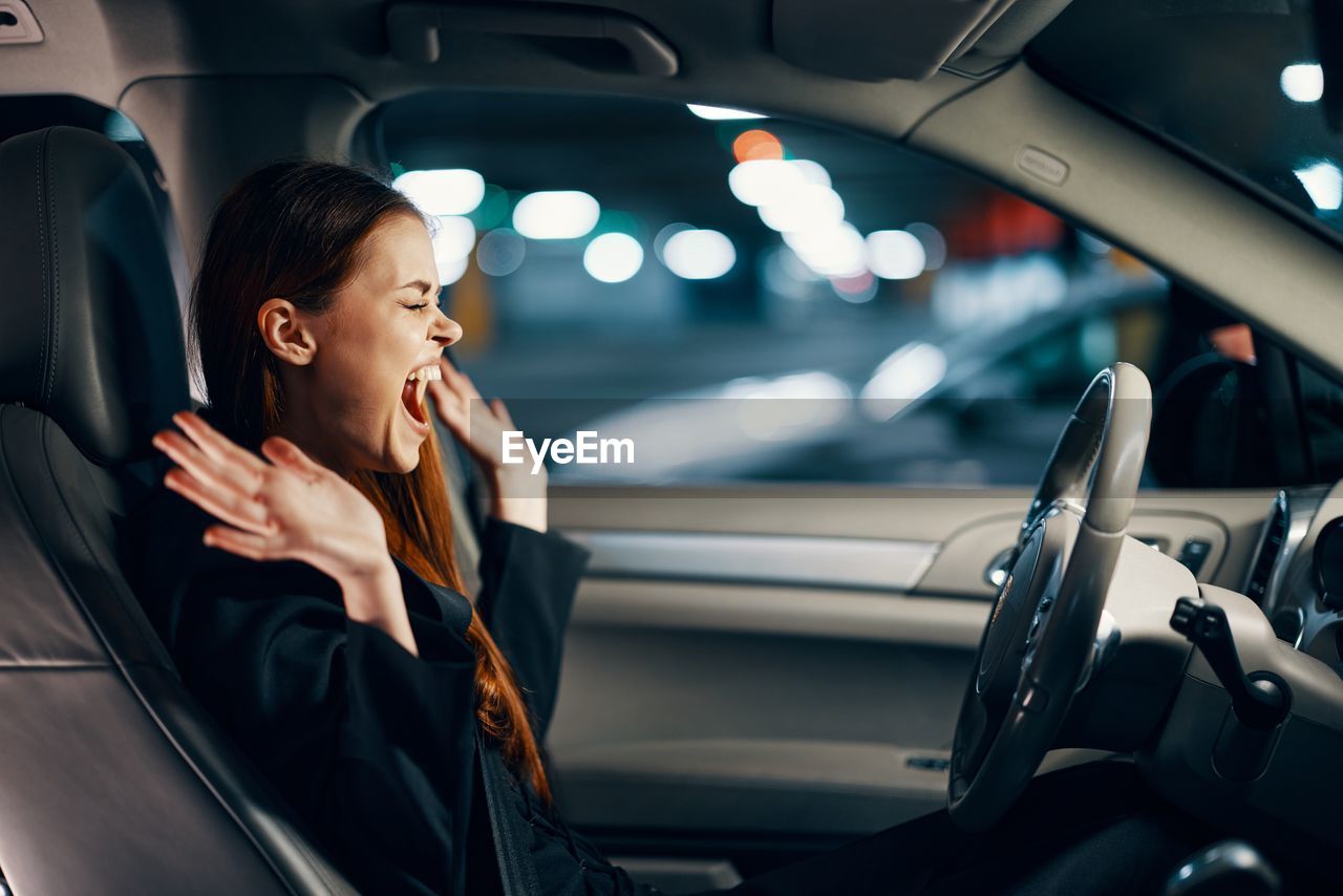 Woman screaming sitting in car
