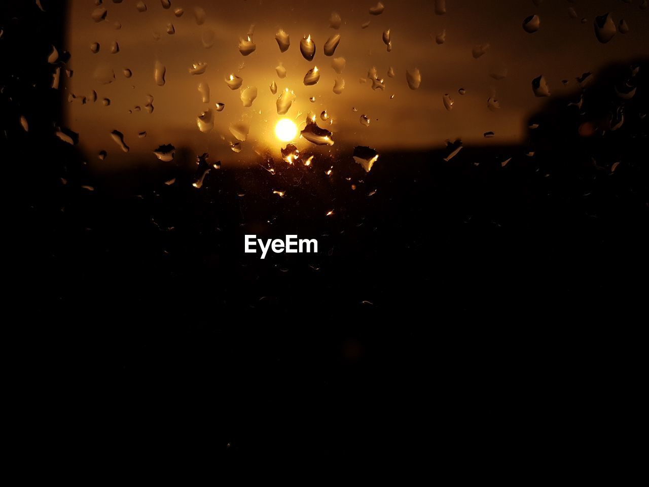 CLOSE-UP OF RAINDROPS ON GLASS