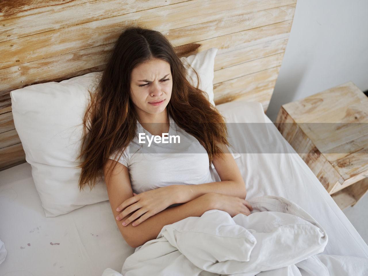 High angle view of depressed woman relaxing at home