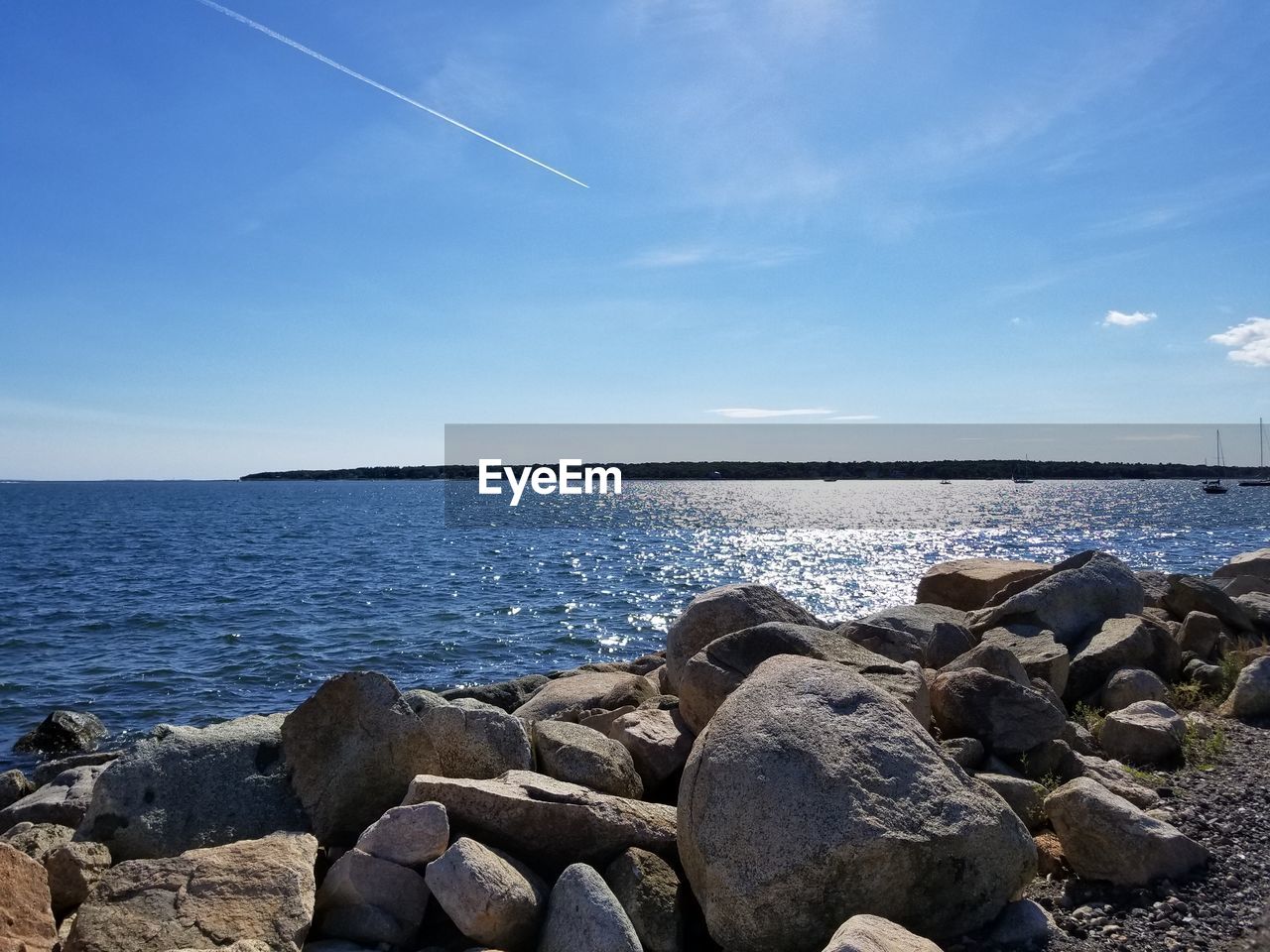 ROCKS ON SHORE AGAINST SKY