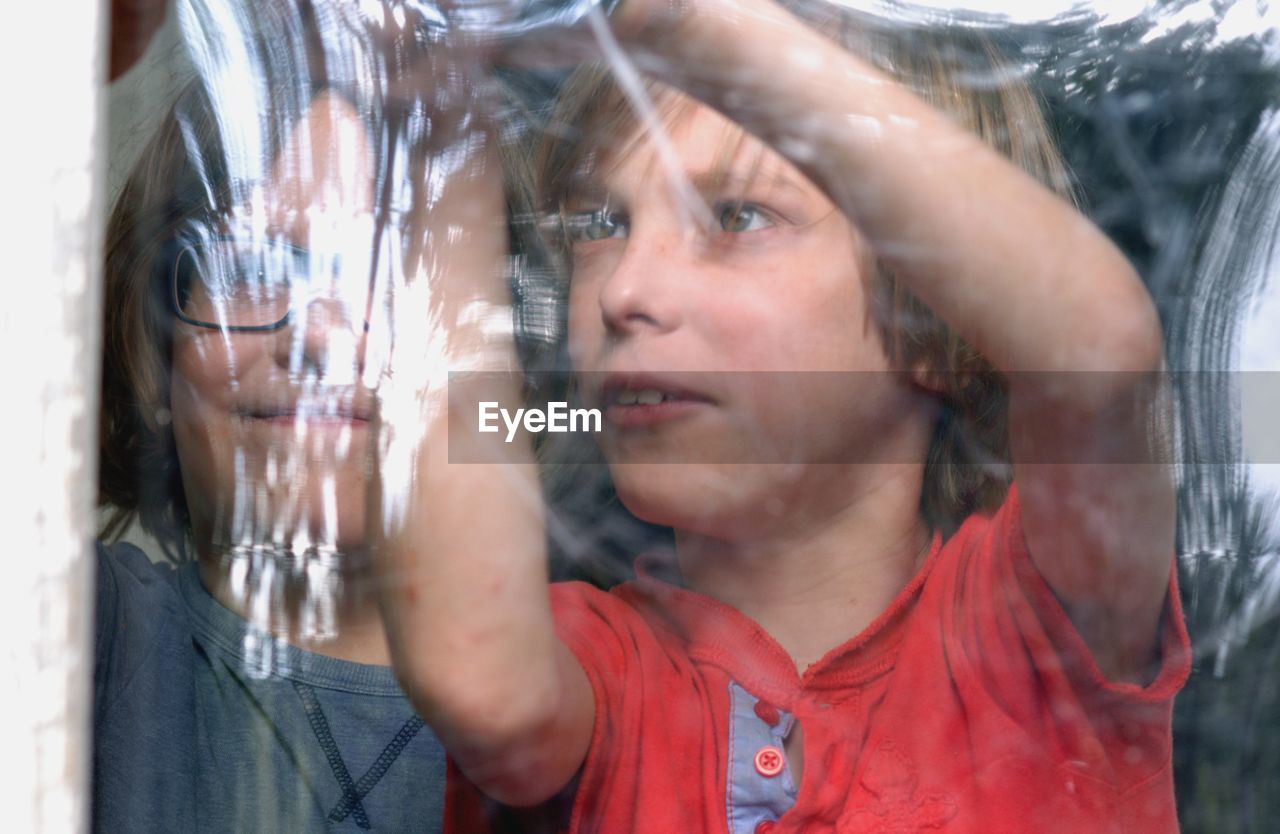 Boys standing by window