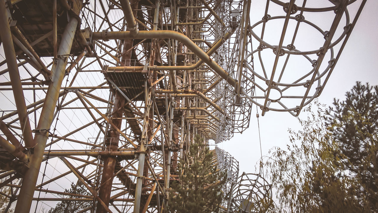 LOW ANGLE VIEW OF ABANDONED TOWER AGAINST SKY