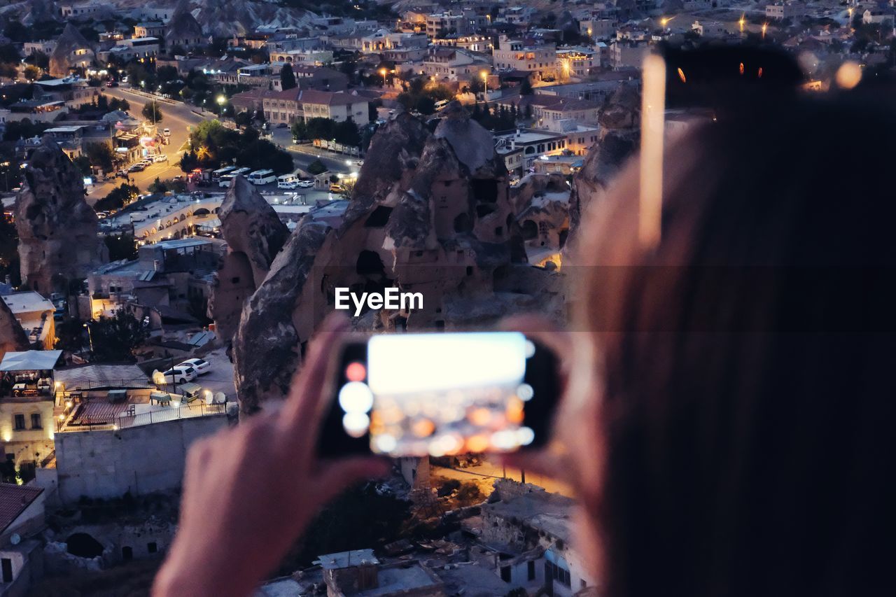 Close-up of woman photographing cityscape