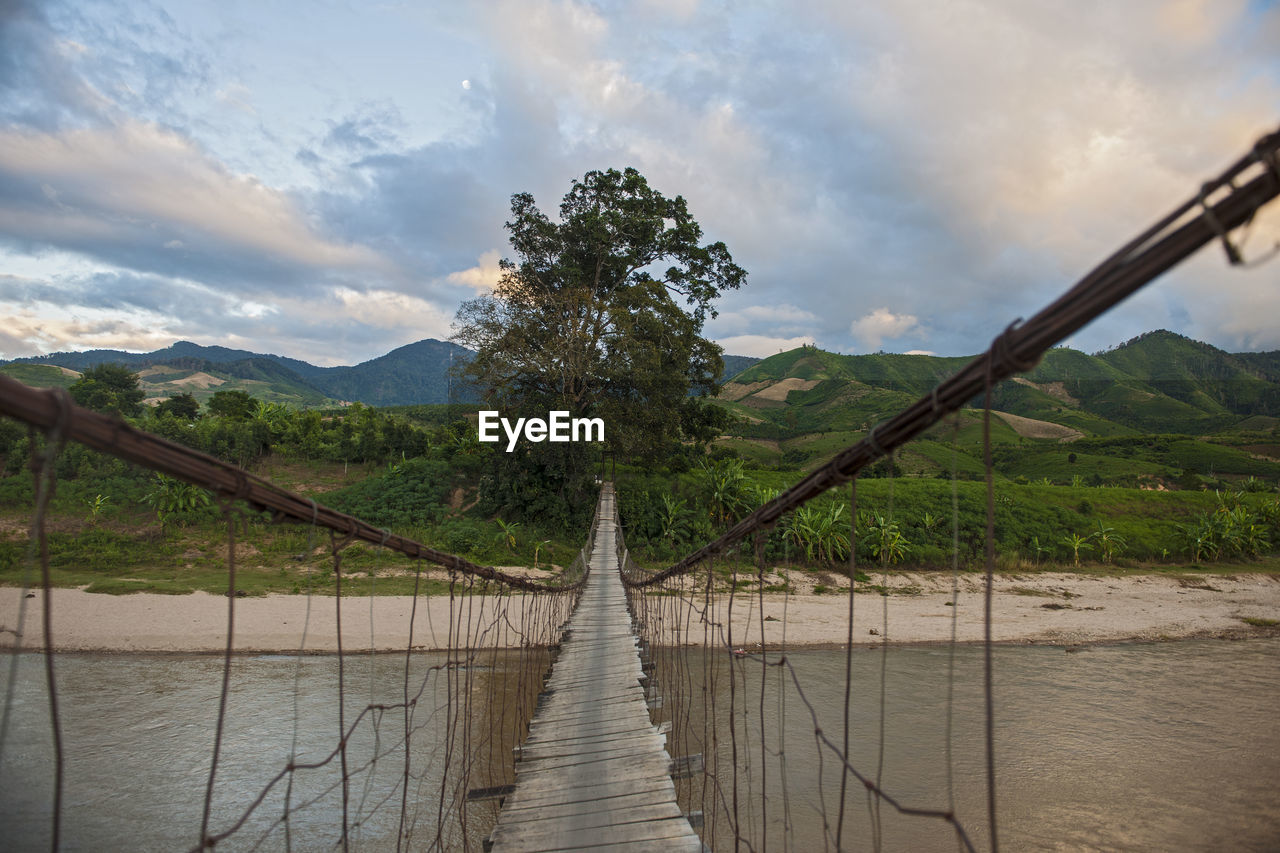 Sketchy suspension footbridge in rural area of vietnam