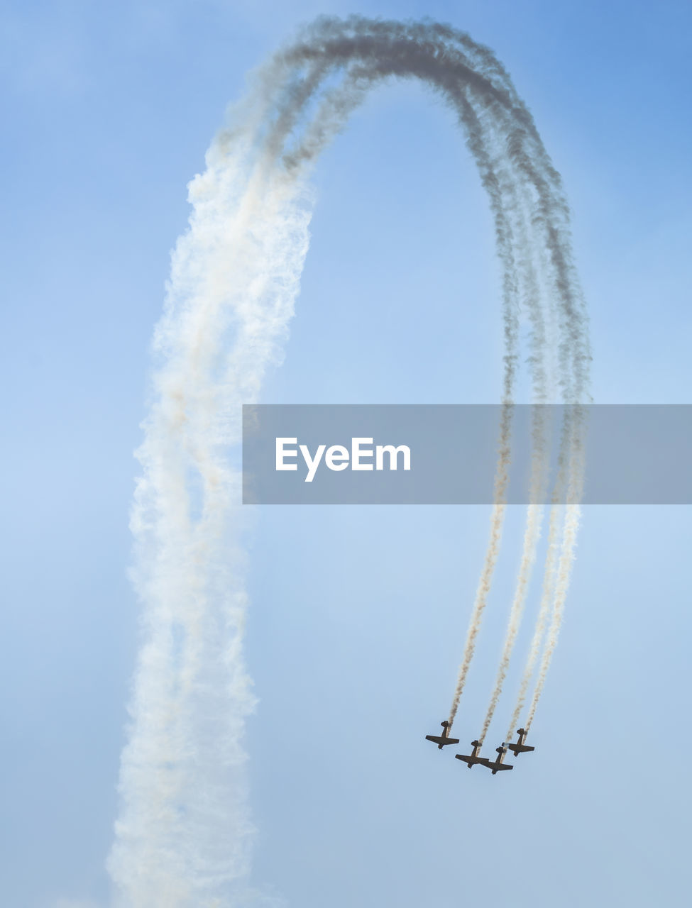 Low angle view of military airplanes performing airshow against sky