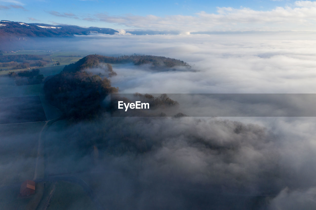 AERIAL VIEW OF CLOUDS OVER MOUNTAIN