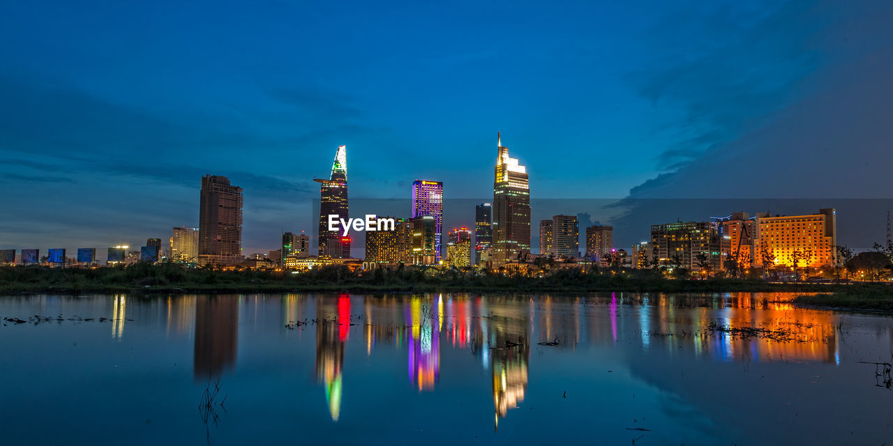 Reflection of illuminated buildings in city at night