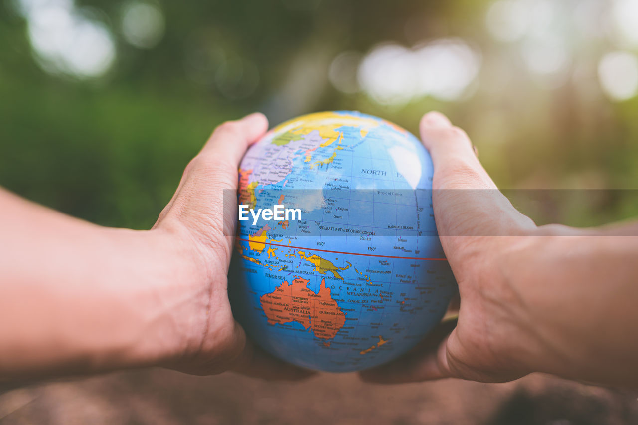 Close-up of hand holding globe