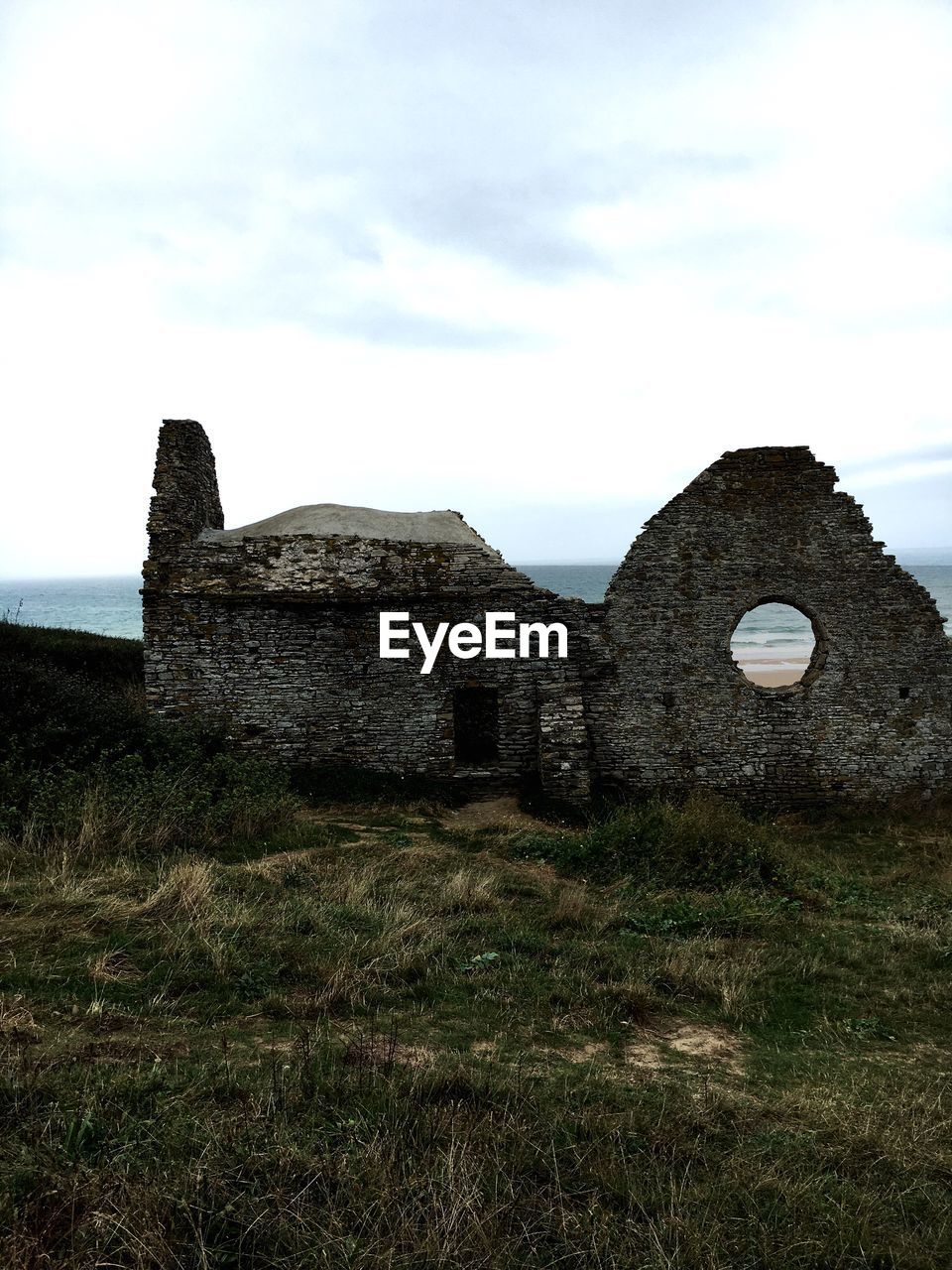 CASTLE BY SEA AGAINST SKY