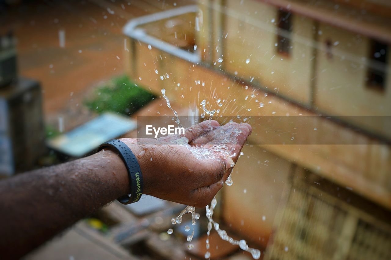 Close up of rain droplets on hand