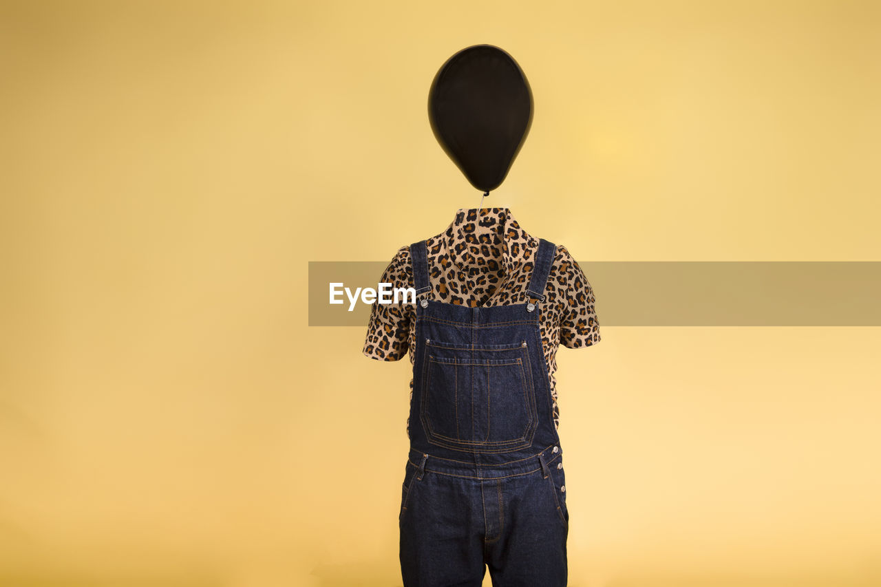 Surreal image of a mannequin with a balloon on his head