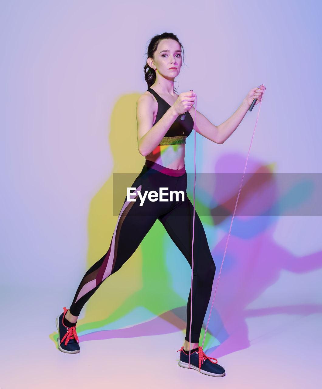 Attractive woman doing stretching exercise or yoga moves with glitch duotone effect