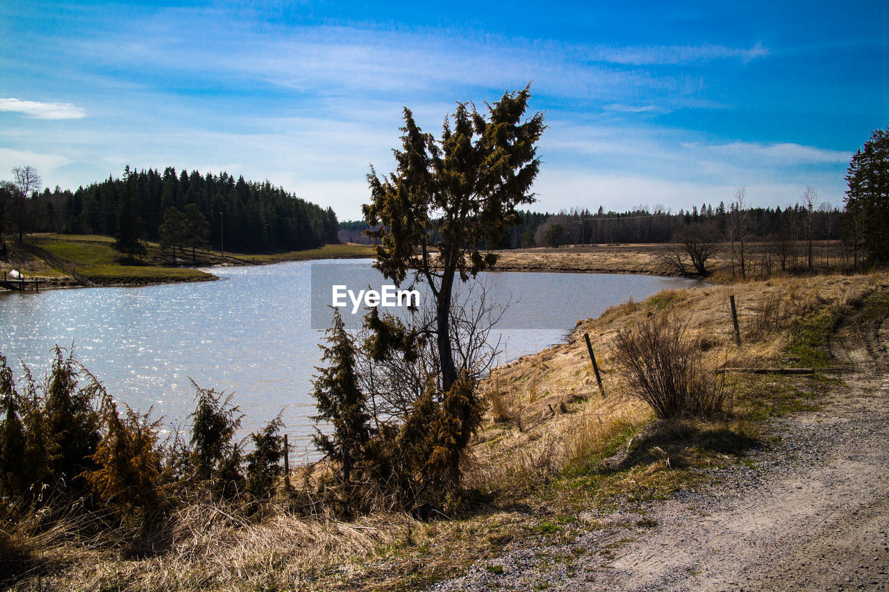 SCENIC VIEW OF LAKE AGAINST CLOUDY SKY