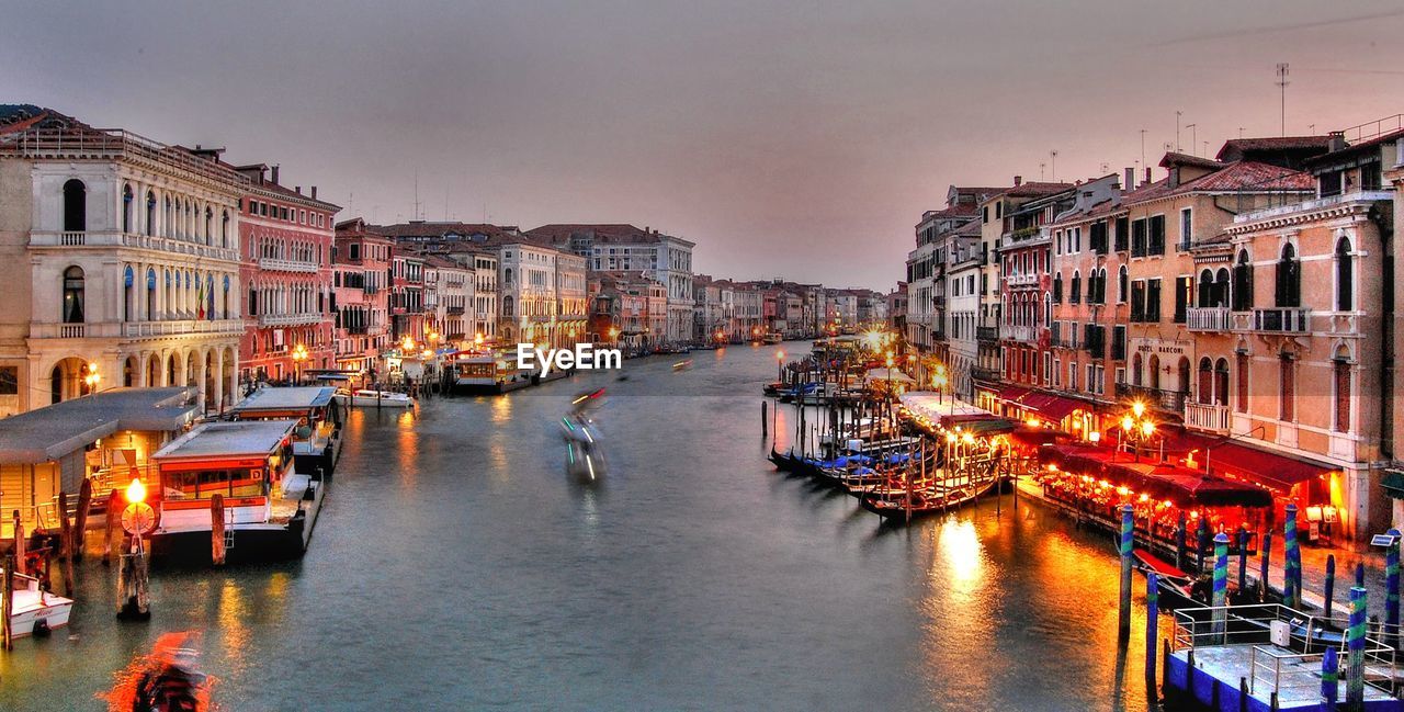 High angle view of boats on canal in illuminated city