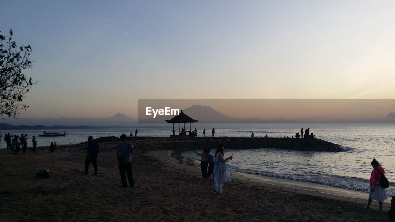 PEOPLE AT BEACH DURING SUNSET