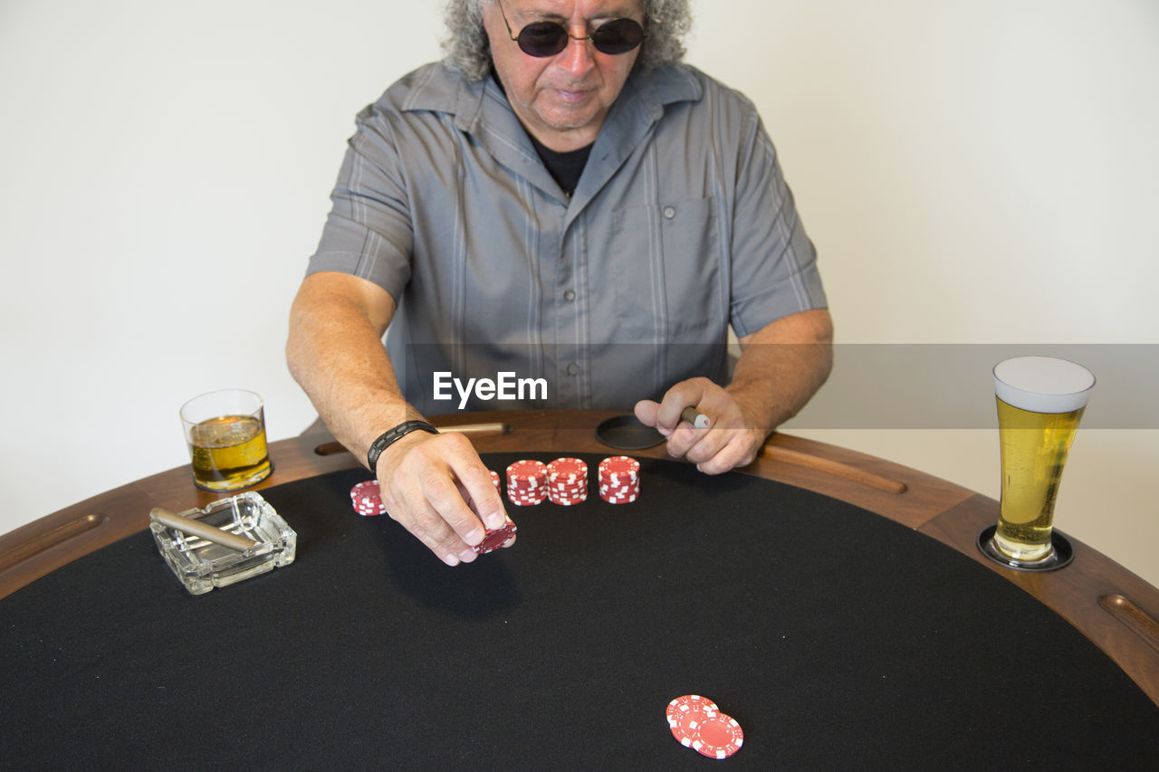 Man playing poker while sitting at table