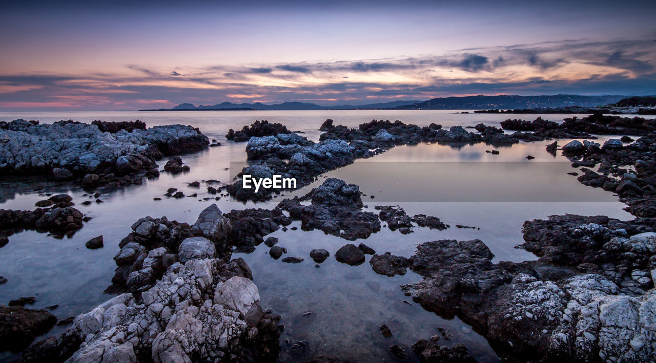 Scenic view of sea against cloudy sky